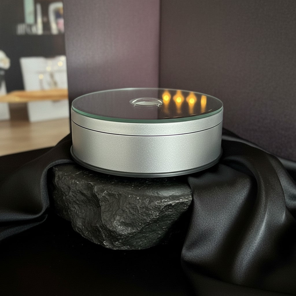 Sarnia3Dcrystals 115mm rotating LED display base in silver with a mirrored top surface on a black stone pedestal.