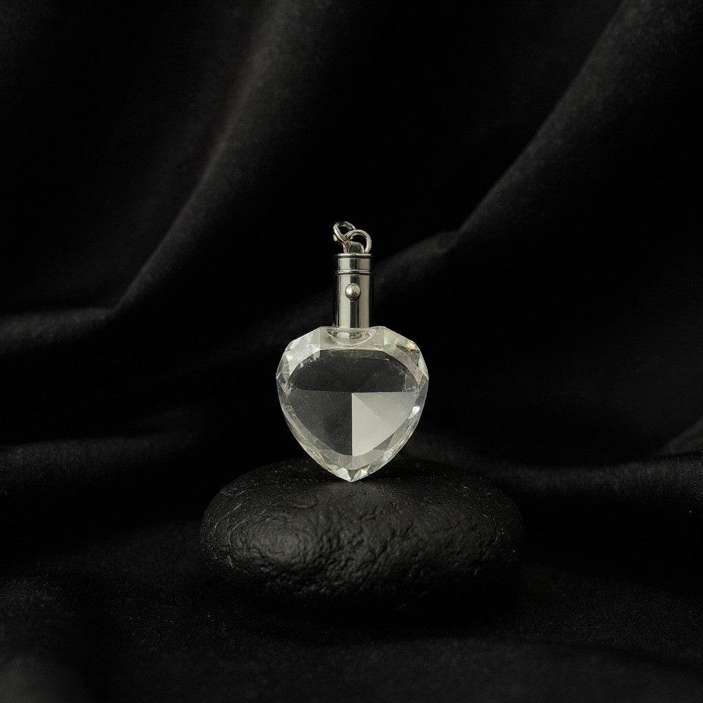 Sarnia3Dcrystals heart-shaped optical crystal keychain with silver hardware displayed on a smooth black stone.