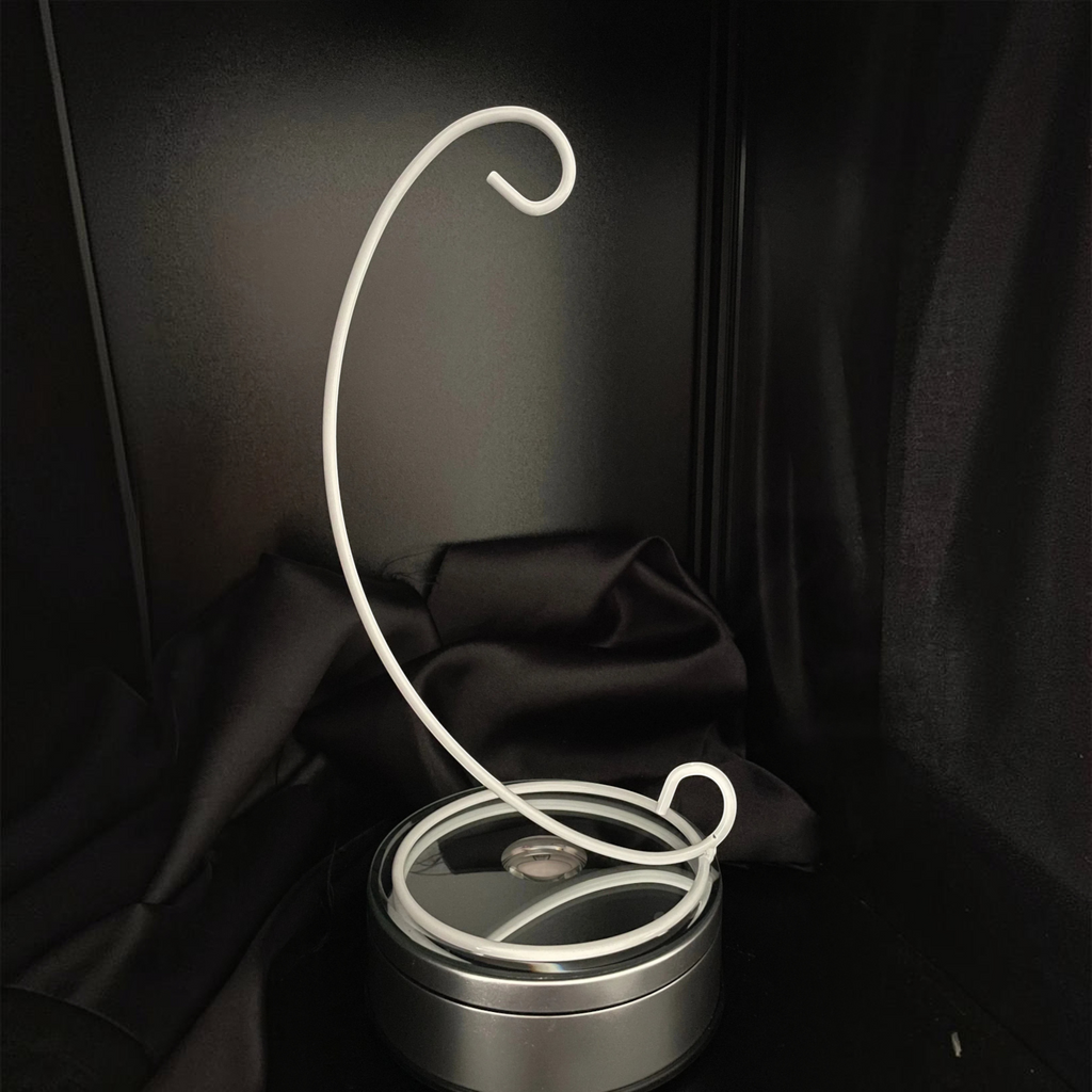 Sarnia3Dcrystals minimalist white metal display stand with a curved arm for ornaments on a black background